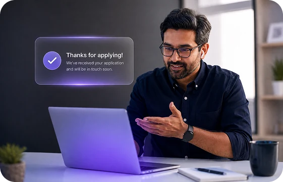 An accountant at a laptop with a confirmation message: thanks for applying, we will be in touch soon